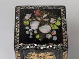 a black and gold box with flowers and butterflies on it