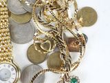 a lot of gold and silver jewelry on a white surface