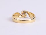 a close up of a gold ring on a white surface