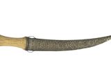 an old knife with a wooden handle on a white background