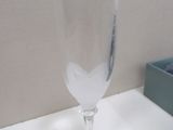a wine glass sitting on a table with a box in the background
