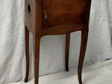 a small wooden table with a drawer on top of it