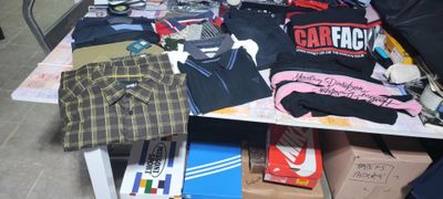 a table with a lot of clothing on top of it