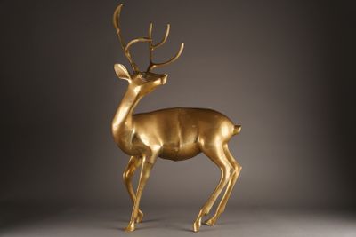 gold deer statue on a grey background with a gray background