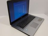 a laptop computer sitting on a white table with a blue screen