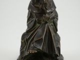 an image of a statue of a man sitting on a chair