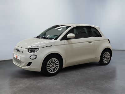 the small white car is parked in a large room