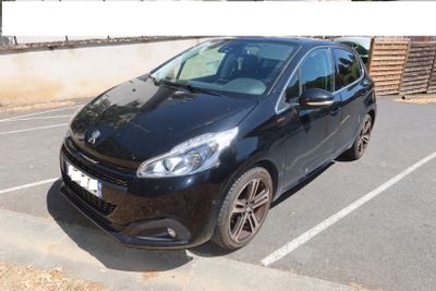 a picture of a black car parked in a parking lot