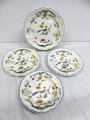 three plates with flowers and leaves on them on a table