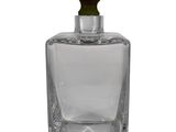 clear glass bottle with a small green plant inside of it