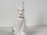 porcelain figurine of a white cat sitting on a white surface
