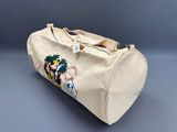 the duffel bag has a picture of a man riding a horse on it