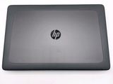 the back of a laptop with the lid open on a white surface