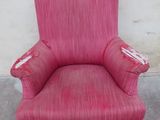 a pink chair with ruffled skirt on it