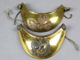 two pieces of gold and silver on a white surface
