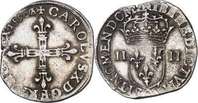 a silver coin with a cross and a crown on it