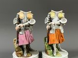 two figurines of a knight and a woman with a dog
