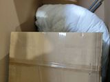 a box with a pillow on top of it in a room