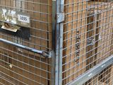 a metal cage with boxes on top of it in a warehouse