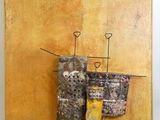 an image of a painting on a yellow wall with a piece of art hanging on it