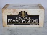 an old box of champagne sitting on top of a marble counter