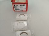 a box of three small white buttons on a white surface