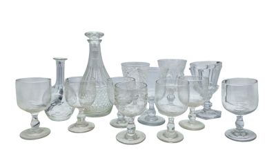 a lot of glasses and vases sitting on a table