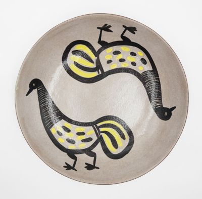 a plate with two birds painted on it