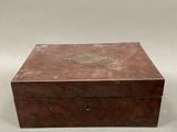 an old wooden box sitting on top of a white surface