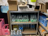 many bottles of water sitting on a shelf in a room