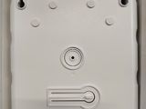 a close up of a white box with a button on it