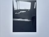 an image of a black and white photo of a room with a window