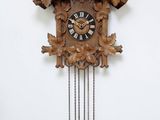 une horloge à coucou en bois ornée d'une tête de cerf