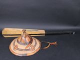 a baseball bat and a hat sitting on a table