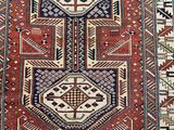 a red and blue rug with geometric design