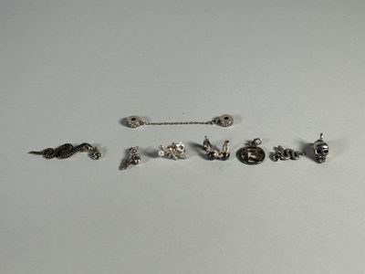 five pairs of earrings that are sitting on a table