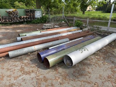 many pipes that are laying out in the dirt