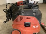 an orange and black vacuum cleaner sitting on top of a cement floor