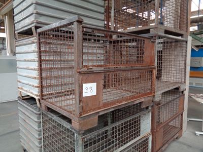 many cages stacked on top of each other in a warehouse