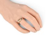 a close up of a person ' s hand with a ring on it