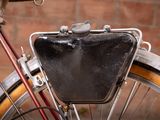 a close up of a bike with a bag on the back