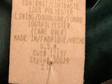 a label on a green jacket with a name tag on it