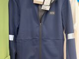 a blue jacket hanging on a hanger in a store
