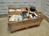 a wooden box filled with assorted items on the floor