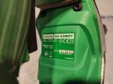 a close up of a green moped parked on the street