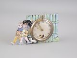 a small clock with a picture of a boy and a girl