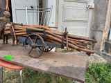a wooden cart with a bunch of sticks on it