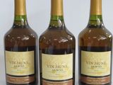 three bottles of wine sitting next to each other on a white surface