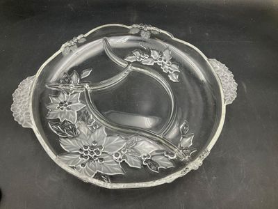 a glass plate with flowers on it on a table