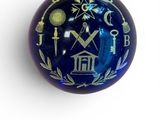 an image of a blue glass ball with masonic symbols on it